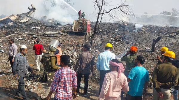 Rescue personnel and local residents gather near a firecracker plant following an explosion at Harda district in Madhya Pradesh (AFP)